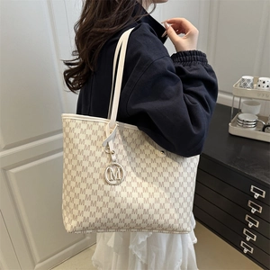 Chic cream tote bag with all-over M letter print and metallic charm for daily commuting