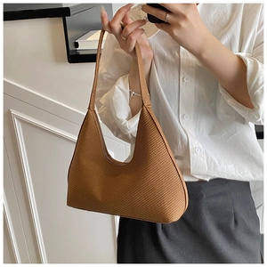 Detail of dark brown hobo bag with woven texture and elegant curved structure