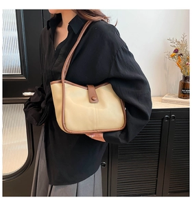 Contrast color tote bag shown on shoulder in a minimalist indoor setting for daily wear