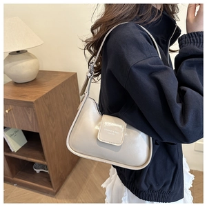 Detail view of beige retro crescent underarm bag with Fashion & Bags printed text