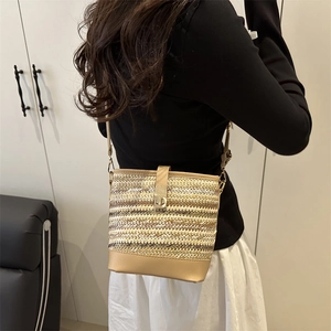 Contrast woven straw bucket bag with brown leather details and metal turn-lock closure