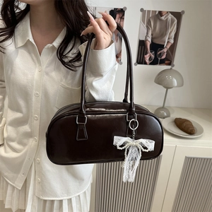 Deep brown glossy Boston bag with a white lace pearl bow on a chic shoulder handbag