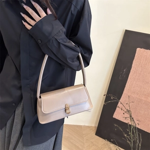 Chic beige minimalist baguette shoulder bag with elegant gold metal clasp for women