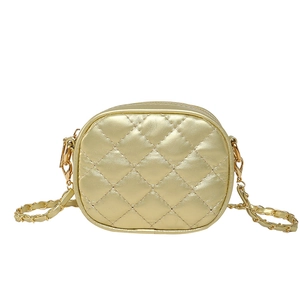 Elegant gold quilted oval mini crossbody bag with leather-wrapped chain strap for women