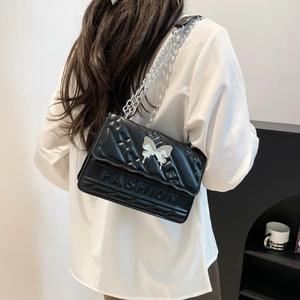 Minimalist black quilted leather crossbody bag with silver butterfly and chain strap