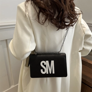 Minimalist black square crossbody bag with SM letter patch and metal chain strap