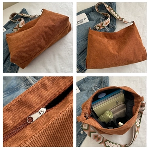 Detail view of brown corduroy tote bag showing spacious interior and geometric wide strap