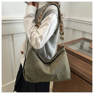 Detail of olive green corduroy tote bag featuring a geometric ethnic style wide shoulder strap