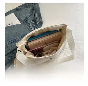 Interior view showing the large capacity of the white nylon bag for daily essentials