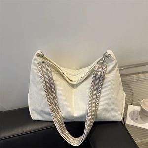 Minimalist corduroy tote bag in cream white with a geometric pattern shoulder strap