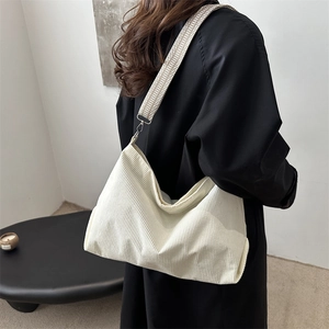 Minimalist beige corduroy tote bag with wide geometric pattern shoulder strap