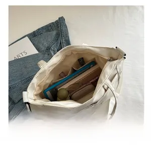 Spacious white canvas tote bag showing organized interior compartments and daily essentials