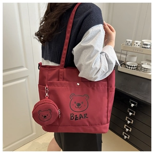 Detail of red cartoon bear tote bag with matching coin purse and side pocket utility