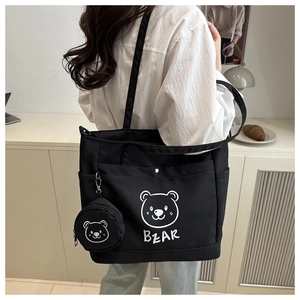 Detail of black tote bag with white bear print and matching small round coin purse
