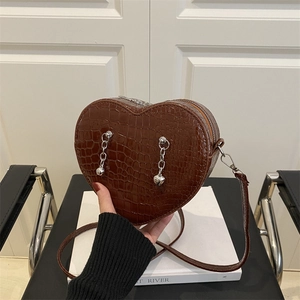 Brown heart-shaped crossbody bag with crocodile texture and silver chain charms