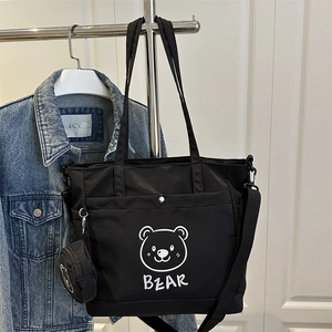 Black nylon tote bag with bear print and small round pouch, perfect for daily commuting