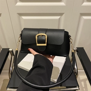 Chic black faux leather baguette bag with a bold gold square buckle and round handle