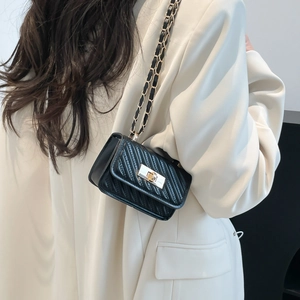 Chic black quilted crossbody bag with gold chain strap and turn-lock closure for women