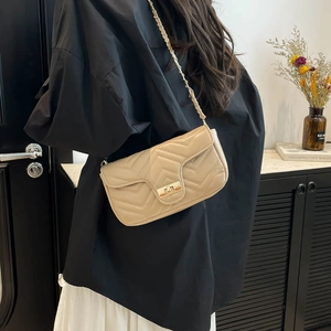 Beige quilted chain shoulder bag with classic V-stitch pattern and gold metal twist lock