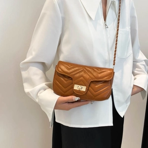 Brown chevron quilted crossbody bag with gold chain strap and turn-lock closure