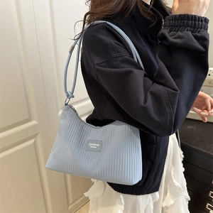 Light blue pleated shoulder bag with JINGPIN fashion label shown on female model