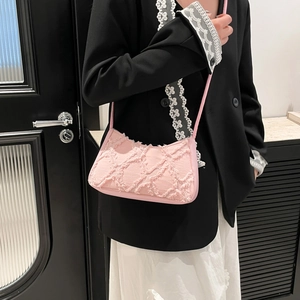 Pink fringed denim underarm bag for women with sleek shoulder strap and chic design