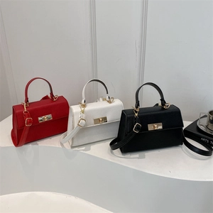 Three lychee grain leather handbags in red, white and black with gold turn-lock closures