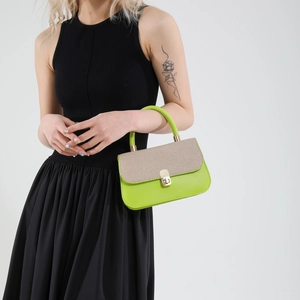 Minimalist green and beige shoulder bag with top handle and golden twist-lock closure