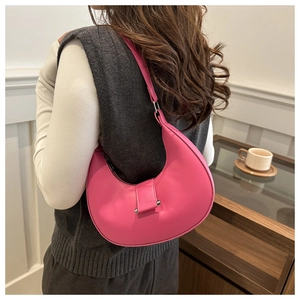 Detailed view of pink crescent hobo bag with metallic silver buckle closure