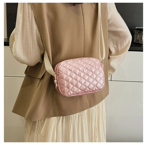 Vue détaillée du sac bandoulière rose matelassé avec rembourrage doux et sangle