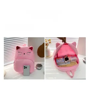 Pink plush cat backpack for kids showing spacious interior for stationery and books