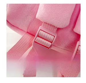 Detailed macro of the pink plush baby backpack adjustable shoulder strap plastic buckle