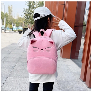 Close-up of pink plush cat backpack with embroidered whiskers and 3D ears detail