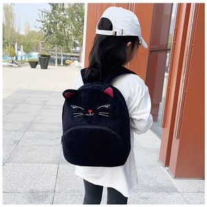 Rear view of a child wearing a black plush kitten backpack with cute 3D ears