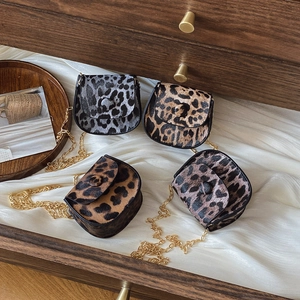 Mini leopard print crossbody bags with gold chains in four colors on white silk