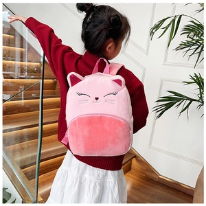 Close-up of a pink plush cat backpack with embroidered details worn by a little girl