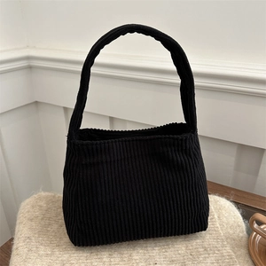 Large black corduroy tote bag with minimalist design for daily spring commuting