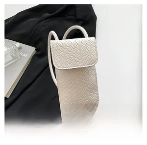 Close-up of white woven texture crossbody phone bag with sophisticated flap design