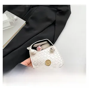 Detail view of the interior capacity and magnetic closure on the woven texture phone bag
