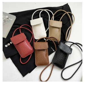 Detailed view of crocodile patterned mini crossbody phone bags in five elegant colors