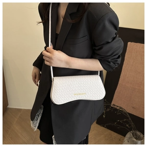 Close-up of white crocodile texture crossbody bag with gold Fashion & Bags lettering