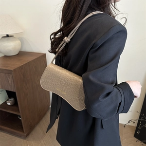 Chic beige crocodile pattern shoulder bag with golden text for a modern urban style