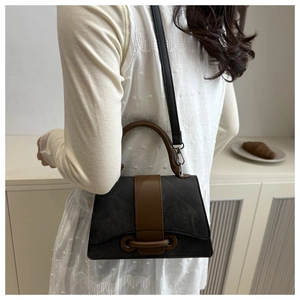 Detail of vintage square crossbody bag in grey and brown with unique buckle and strap