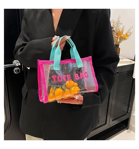 Detail of pink transparent mini tote bag with blue handles and bold printed text