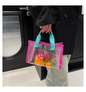 Detail of transparent PVC tote bag with love print and pink mesh side panels