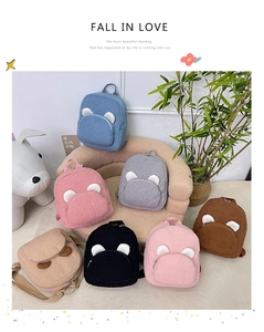 Detail of plush bear-ear backpacks in various colors with soft faux fur texture