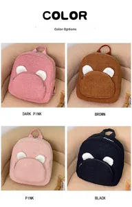 Detail view of plush backpacks with bear ears in dark pink, brown, pink and black colors