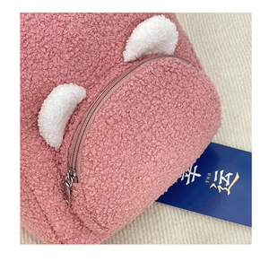 Close-up of pink faux fur texture and white ear details on this mini teddy backpack