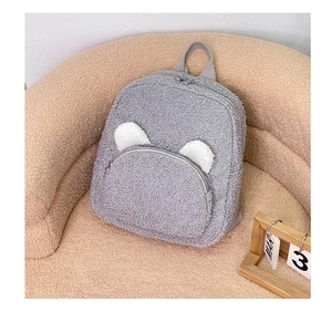 Detail of gray plush teddy backpack featuring soft fleece texture and cute white ears