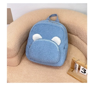 Detailed macro view of blue sherpa backpack with cute white bear ears and zipper pockets
